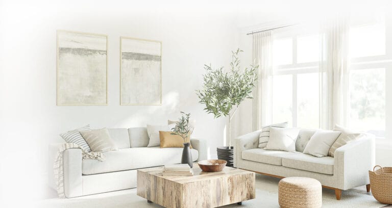 a living room with couches and a coffee table with Christian wall art on the wall