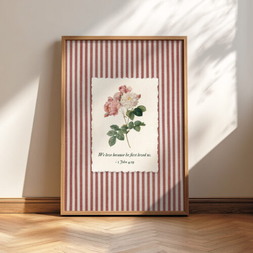 1 John 4:19 Bible verse wall art with rose botanical illustration, pink striped background, we love because he first loved us print